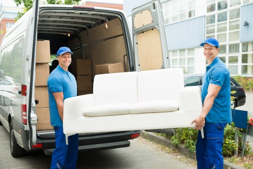 Removal crew loading furniture near a Petersham property