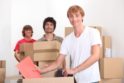 Trained movers loading furniture carefully into a van in Petersham